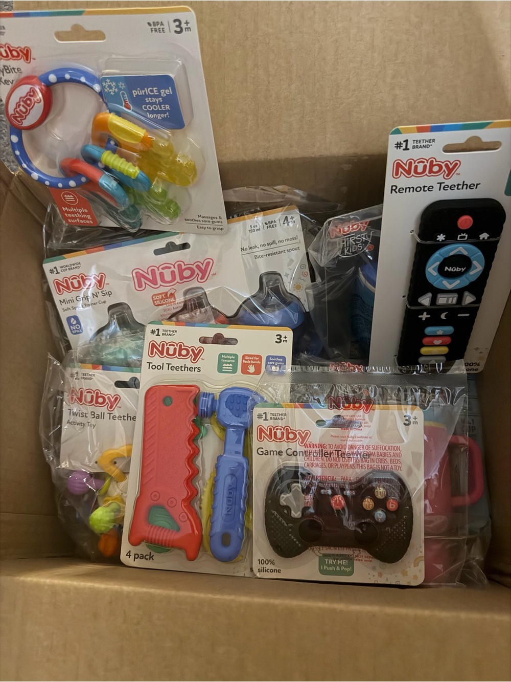 Box filled with brand new nuby toys/teethers